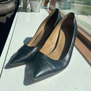 Tory Burch black leather heels with snakeskin toe decal.